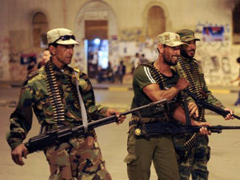 Представитель Каддафи обвинил повстанцев в каннибализме