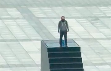 В центре Варшавы мужчина взобрался на памятник и угрожает себя взорвать